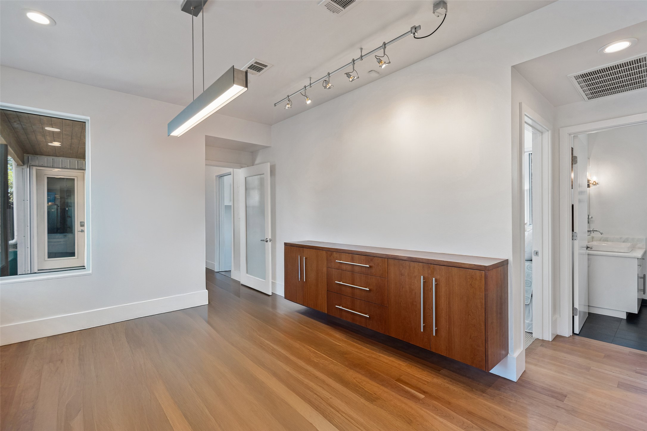 1809 Eva Street Austin, TX 78704 - Photo 15 of 31 a view interior of a house wooden floor and windows