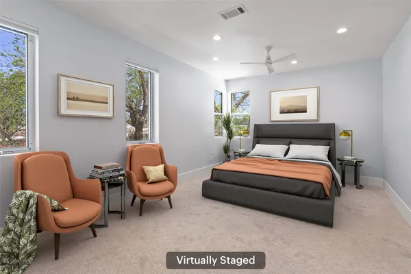 a bedroom with a bed chair and couch