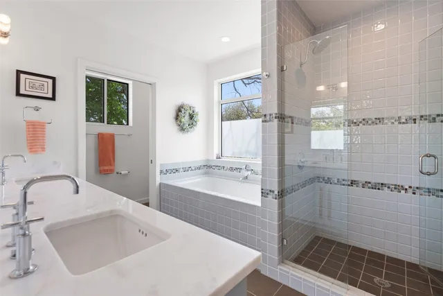 a spacious bathroom with a double vanity sink a mirror and a