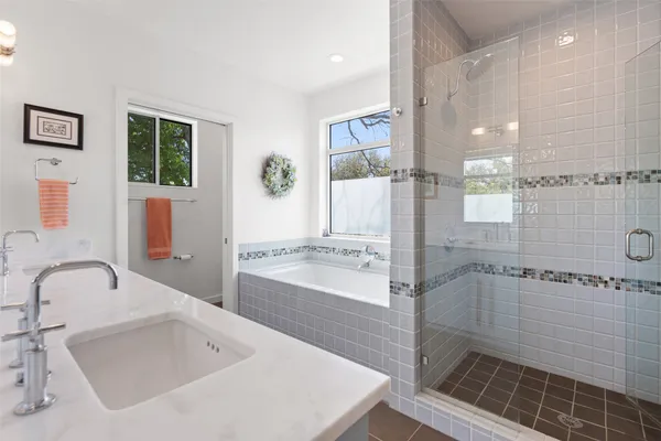 a bathroom with a bathtub and a shower