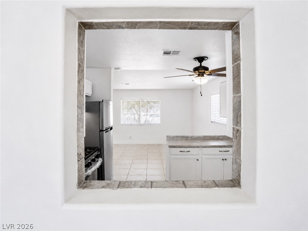 2870 South Sandhill Road Las Vegas, NV 89121 - Photo 33 of 64 A pass-through window connects the well-appointed kitchen to the adjacent living area.