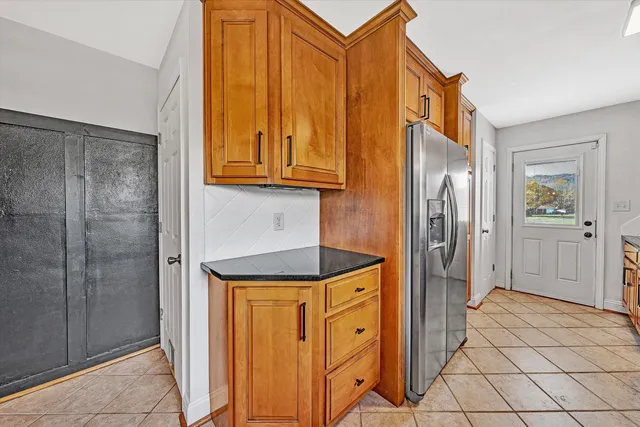 a kitchen with stainless steel appliances granite countertop a sink and a stove