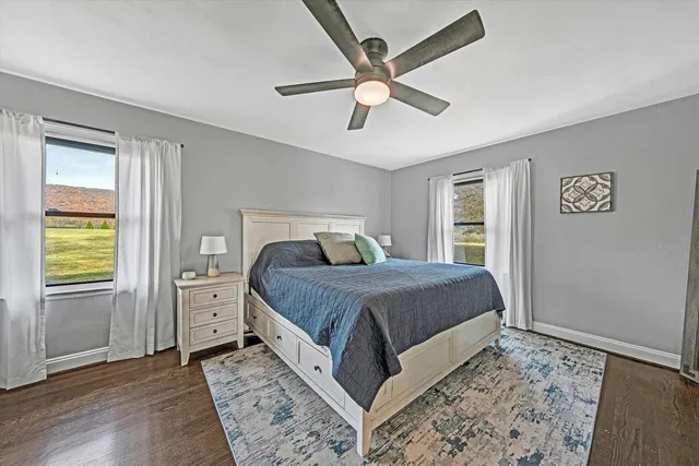 a bedroom with a bed and a flat tv screen on dresser