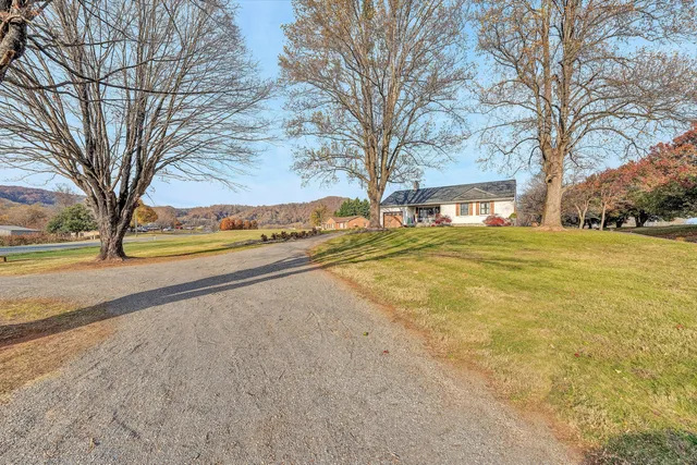 a view of a building with a yard and trees