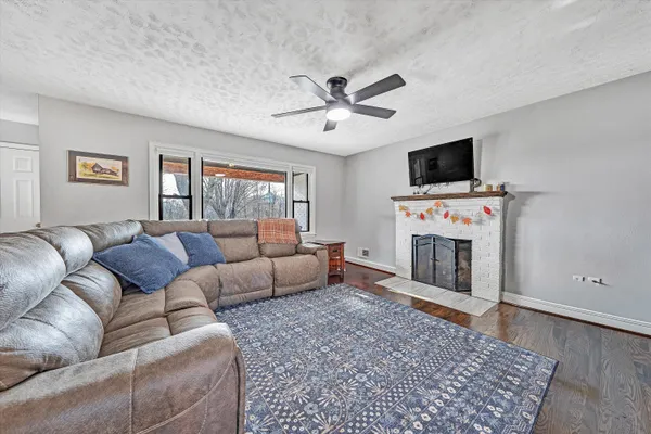 a living room with furniture and view of kitchen