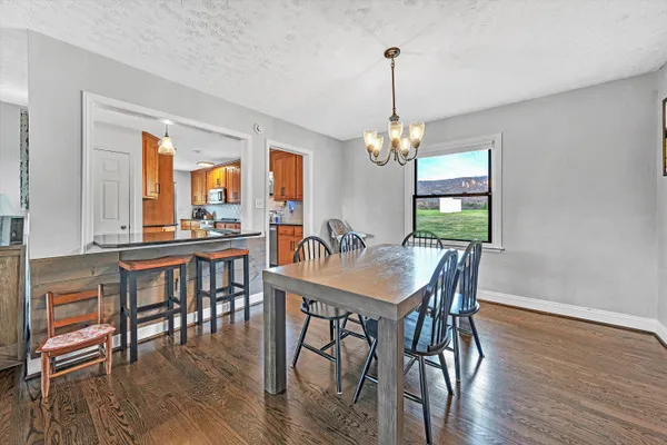a view of a dining room with furniture wooden floor and chandelier