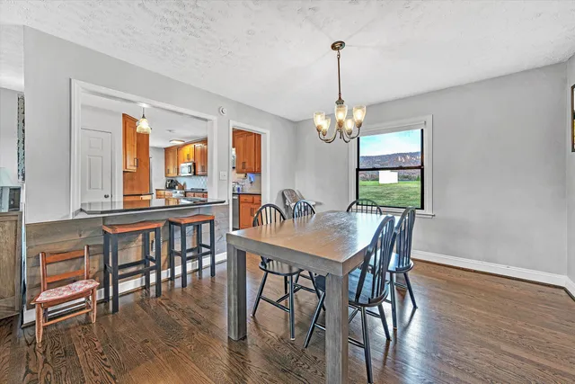 a view of a dining room with furniture wooden floor and chandelier