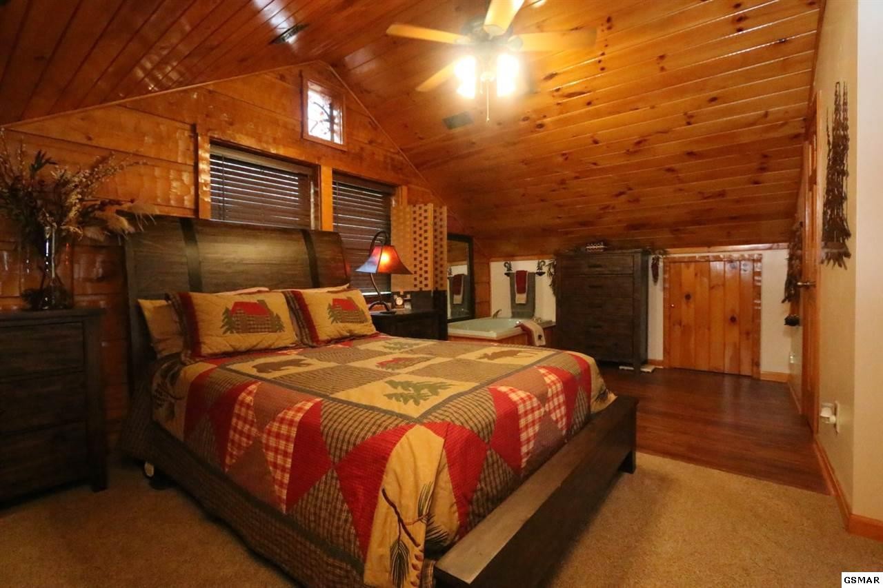 352 Warrior Ridge Way Cosby, TN 37722 - Photo 12 of 23 a bed sitting in a bedroom next to a building