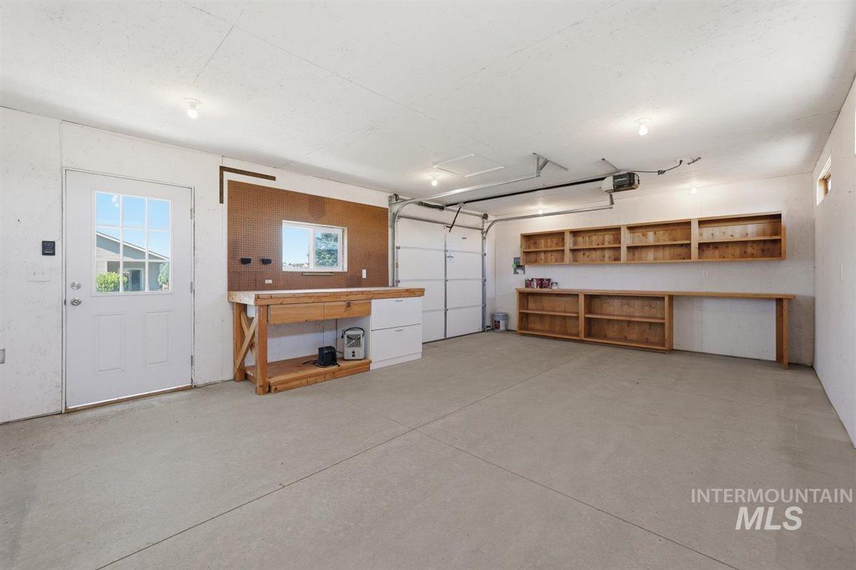 13496 Hockberger Ranch Road Caldwell, ID 83607 - Photo 31 of 40 Spacious garage featuring a concrete floor, overhead lighting, and an overhead garage door