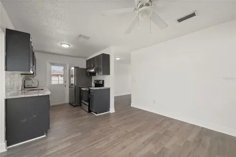 a kitchen with a refrigerator and a sink
