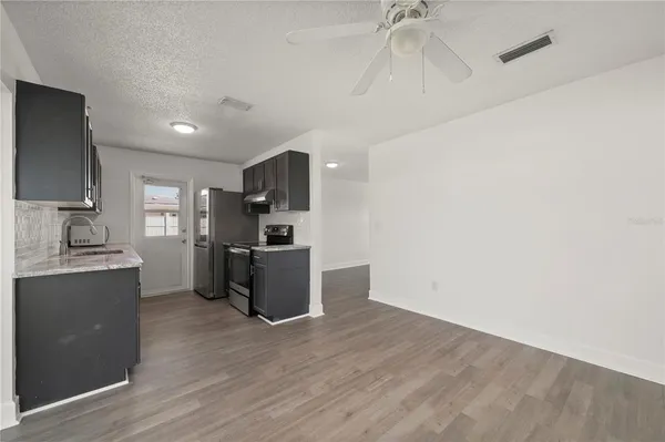 a kitchen with a refrigerator and a sink