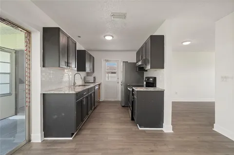 a kitchen with a sink and steel appliances