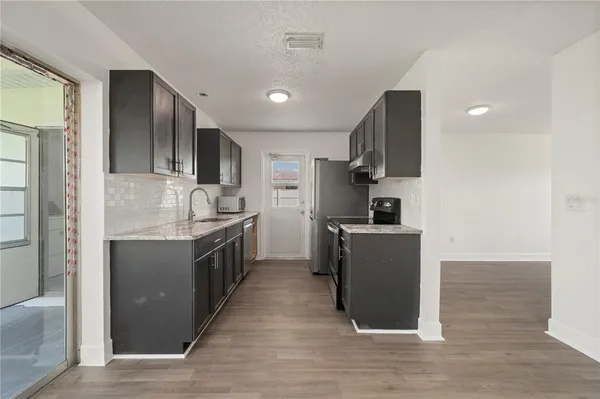 a kitchen with a sink and steel appliances