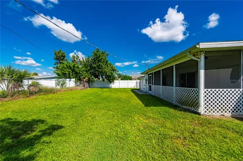 a view of house with a yard