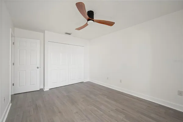 a view of a room with wooden floor