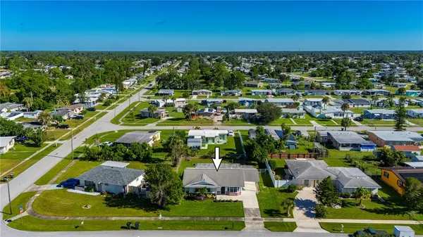a aerial view of multiple houses with yard