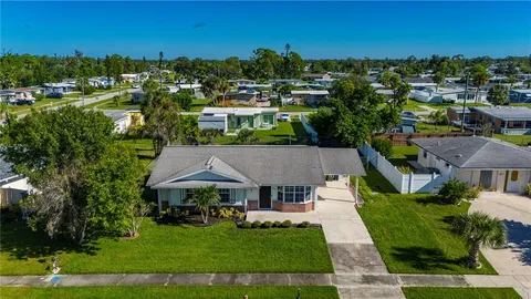 an aerial view of a house with a swimming pool yard and outdoor seating
