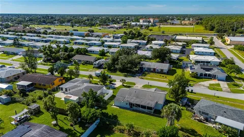 a aerial view of a house with swimming pool yard and outdoor seating