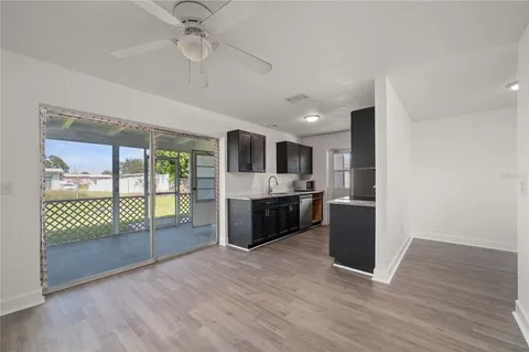 a large kitchen with a large window and stainless steel appliances