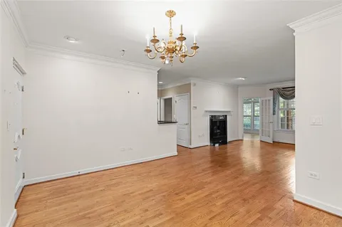a view of an empty room with a kitchen