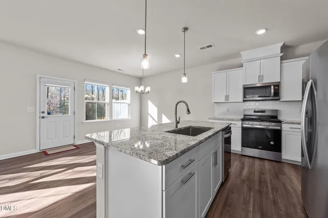 a kitchen with a stove a sink and a refrigerator