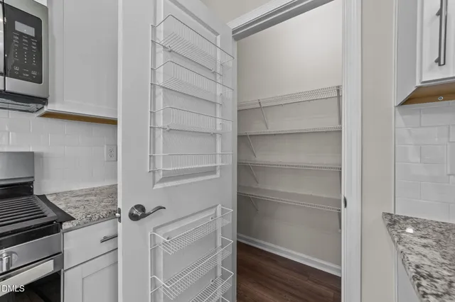 a kitchen with white cabinets and a stove