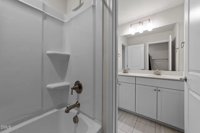 a bathroom with a sink a light fixture and a mirror