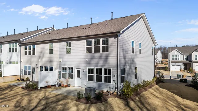 a view of a white building among the street with palm trees