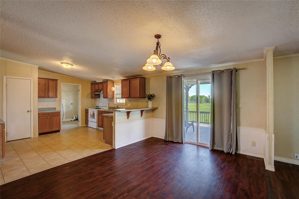 3077 Pecan Court Princeton, TX 75407 - Photo 11 of 37 a view of kitchen with cabinets and wooden floor