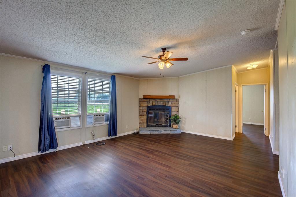 3077 Pecan Court Princeton, TX 75407 - Photo 17 of 37 a view of an empty room with a window and wooden floor