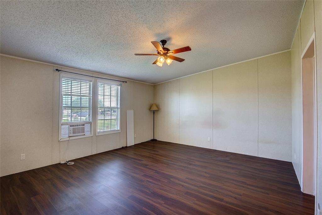 3077 Pecan Court Princeton, TX 75407 - Photo 19 of 37 an empty room with wooden floor and windows