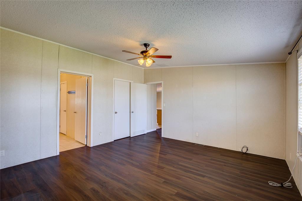 3077 Pecan Court Princeton, TX 75407 - Photo 21 of 37 an empty room with wooden floor and ceiling fan