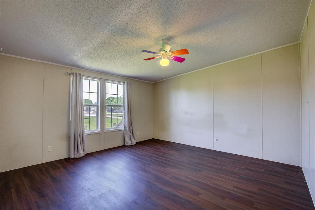 3077 Pecan Court Princeton, TX 75407 - Photo 24 of 37 an empty room with wooden floor and windows