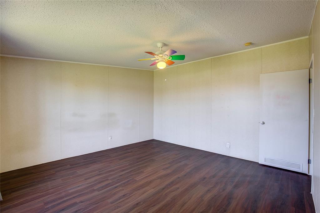 3077 Pecan Court Princeton, TX 75407 - Photo 27 of 37 an empty room with wooden floor and fan