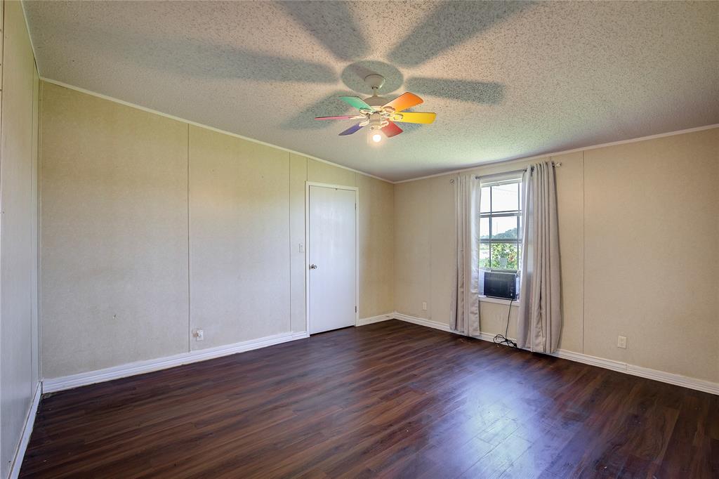 3077 Pecan Court Princeton, TX 75407 - Photo 28 of 37 an empty room with wooden floor and windows