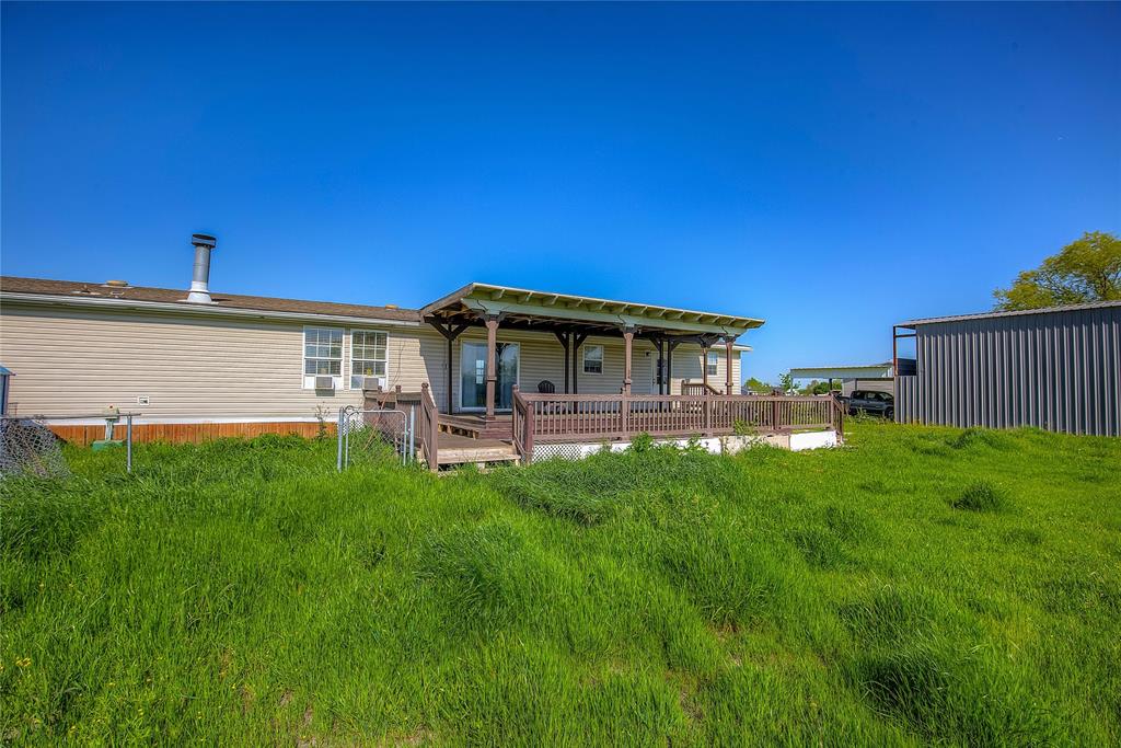 3077 Pecan Court Princeton, TX 75407 - Photo 35 of 37 a view of a house with a backyard
