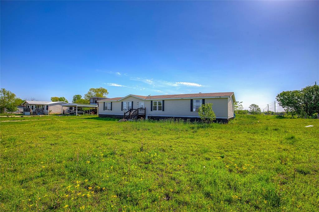 3077 Pecan Court Princeton, TX 75407 - Photo 4 of 37 a front view of a house with a garden