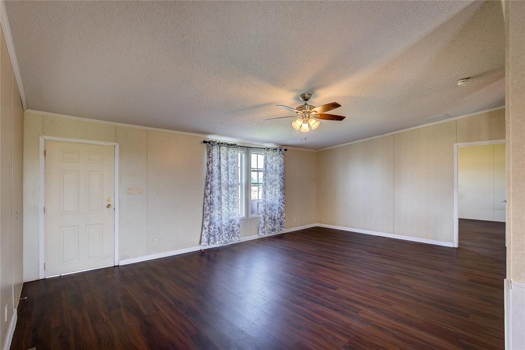 3077 Pecan Court Princeton, TX 75407 - Photo 8 of 37 a view of an empty room with wooden floor and a window