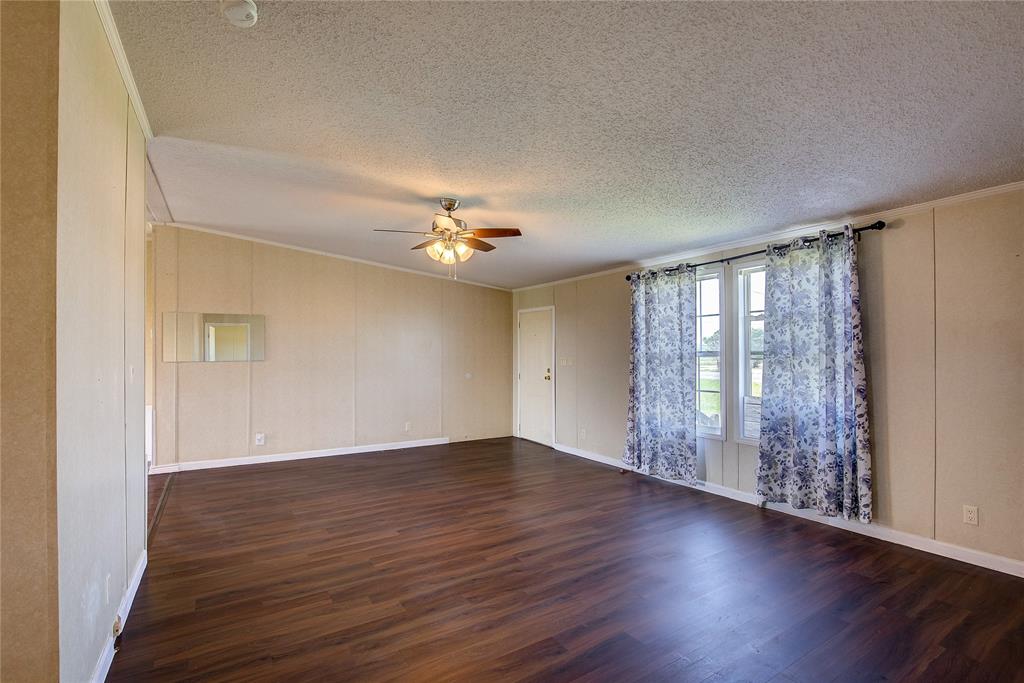 3077 Pecan Court Princeton, TX 75407 - Photo 9 of 37 a view of an empty room with wooden floor and a window