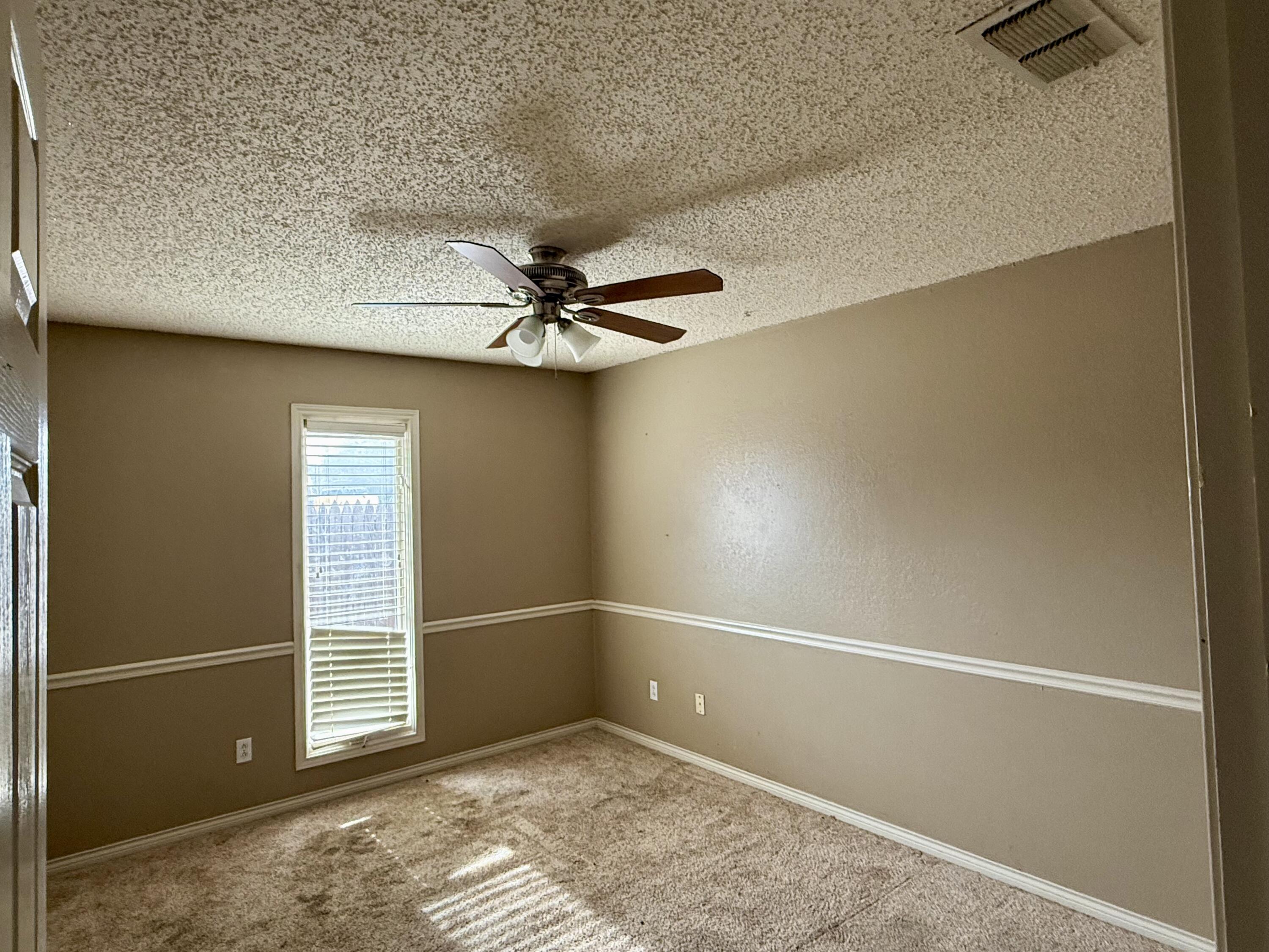 5912 74th Street Lubbock, TX 79424 - Photo 6 of 12 an empty room with a empty space and windows