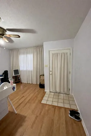a view of a room with wooden floor and windows