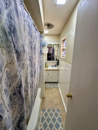 a bathroom with a sink and mirror with toilet