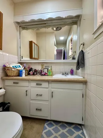 a bathroom with a sink vanity and mirror