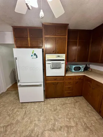 a kitchen with a refrigerator and a stove