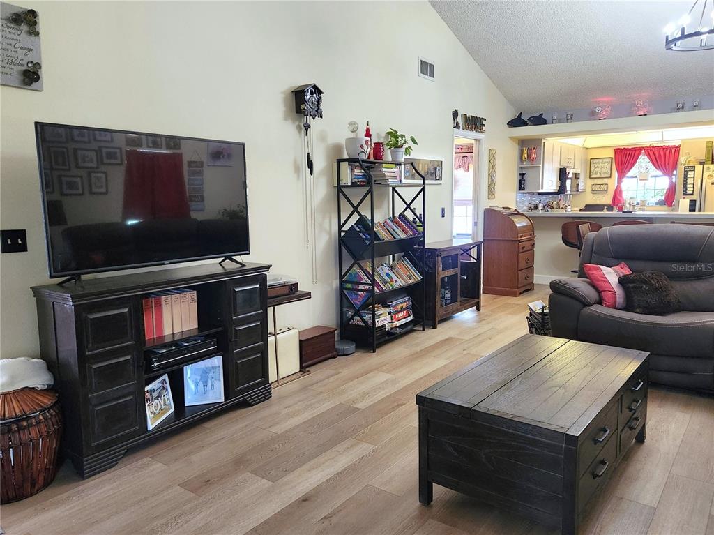1701 Southeast 24th Road, Unit 1601 Ocala, FL 34471 - Photo 5 of 30 a living room with furniture and a flat screen tv