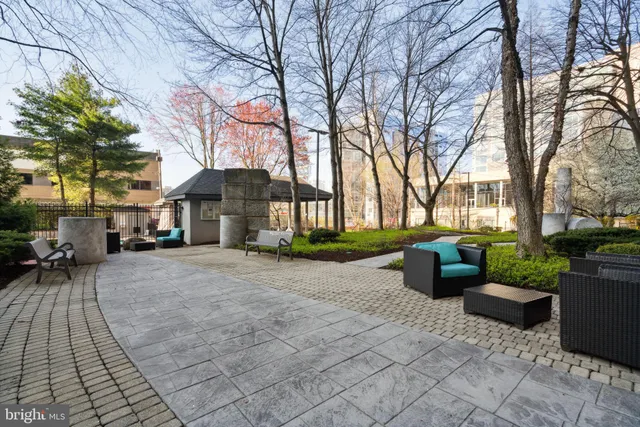 a view of a patio with couches and table and chairs and potted plants