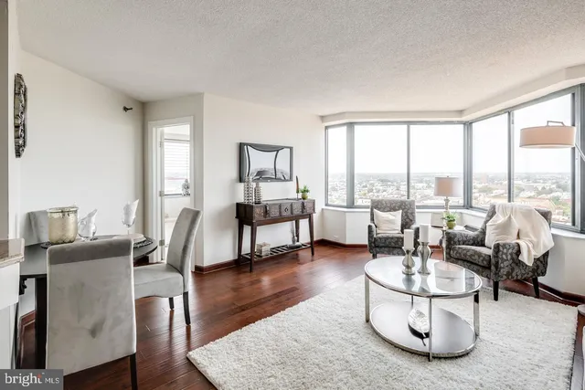 a living room with couches and a pool table with couch