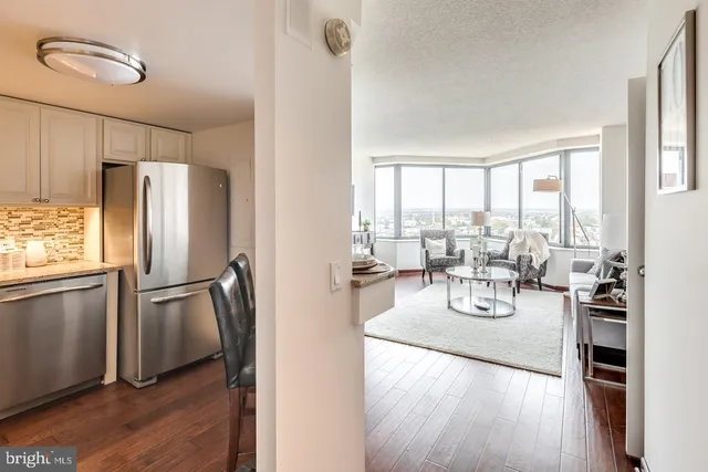 a very nice looking living room with a large window and wooden floor