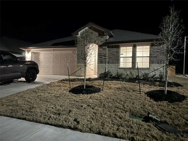 a view of a house with a backyard