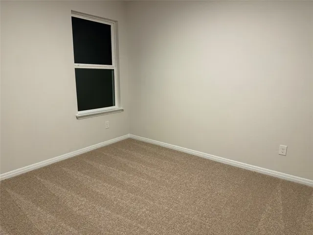 a view of storage and utility room with refrigerator washer and dryer